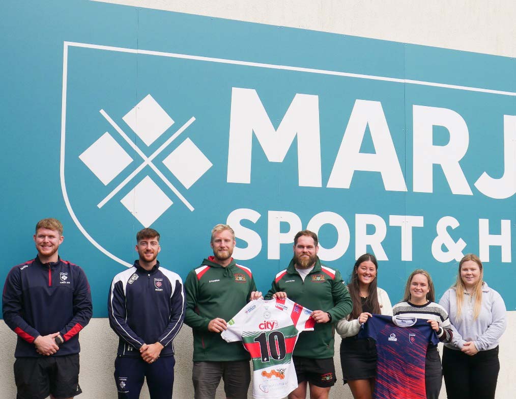 Plymouth Marjon University rugby team captains pose with Plymouth Albion representatives.
