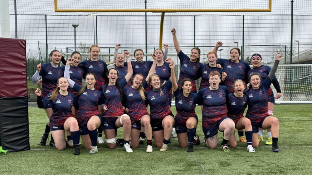 The Marjon women's rugby team celebrate in front of the goal