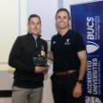 Man receives glass award from another man