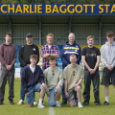 Students and partner colleagues standing on pitch in posed group
